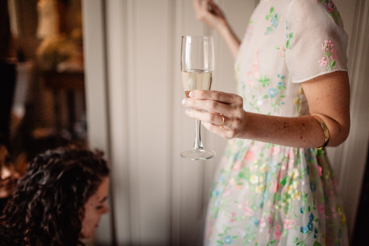 girl holding champagne glass on wedding day