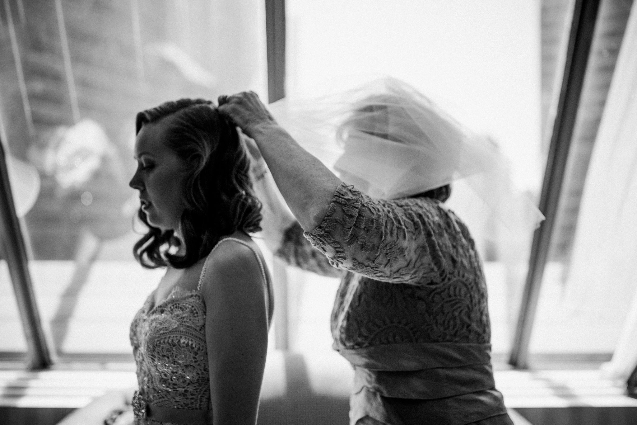 mother of bride helps with veil