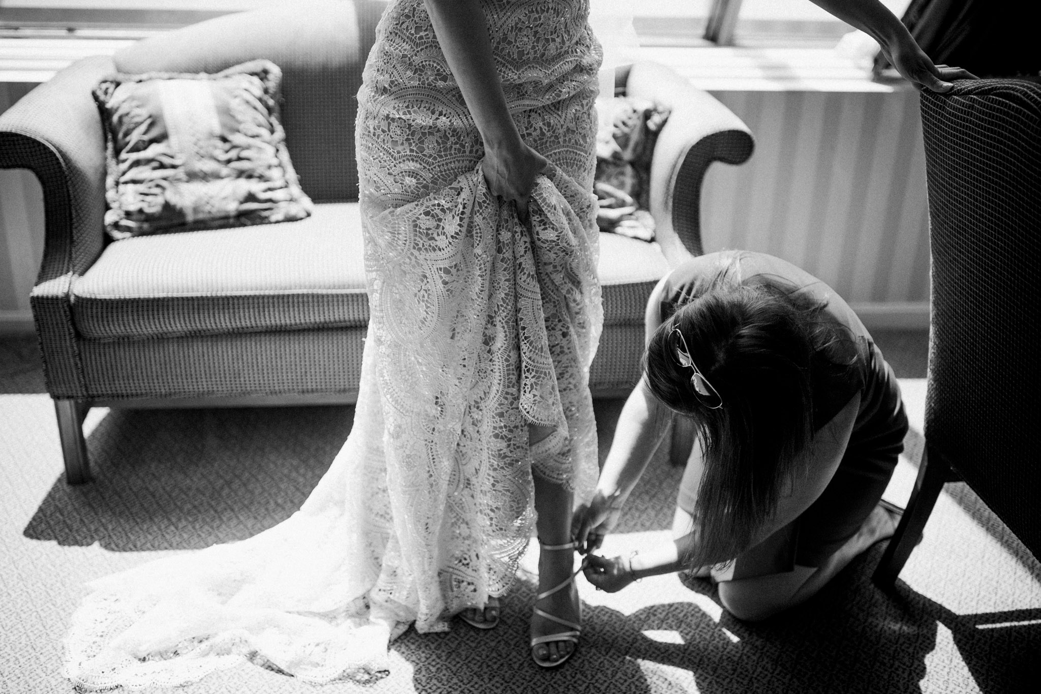 bride putting shoes on before the wedding